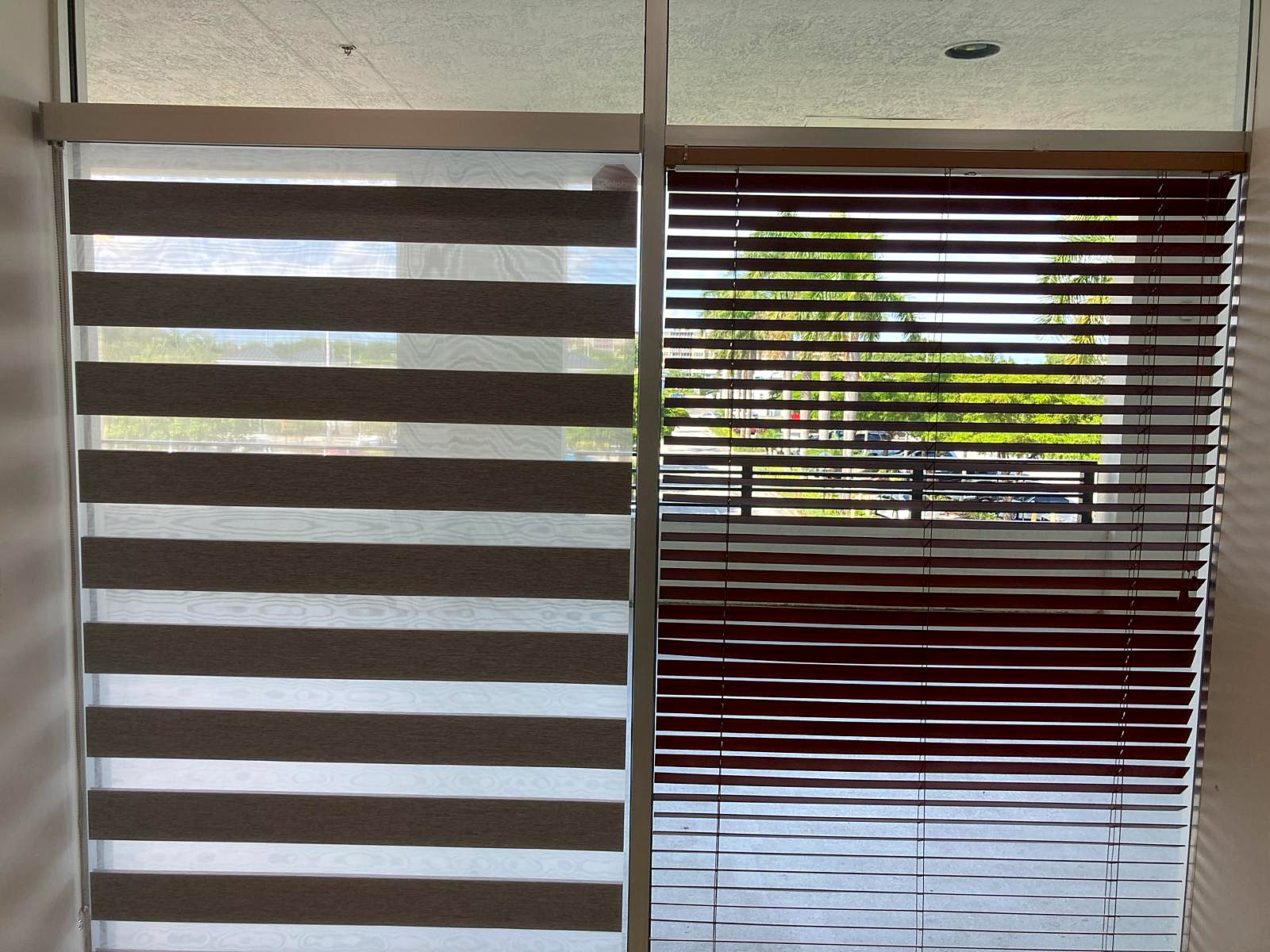 Wood blinds next to a zebra shade in an office window